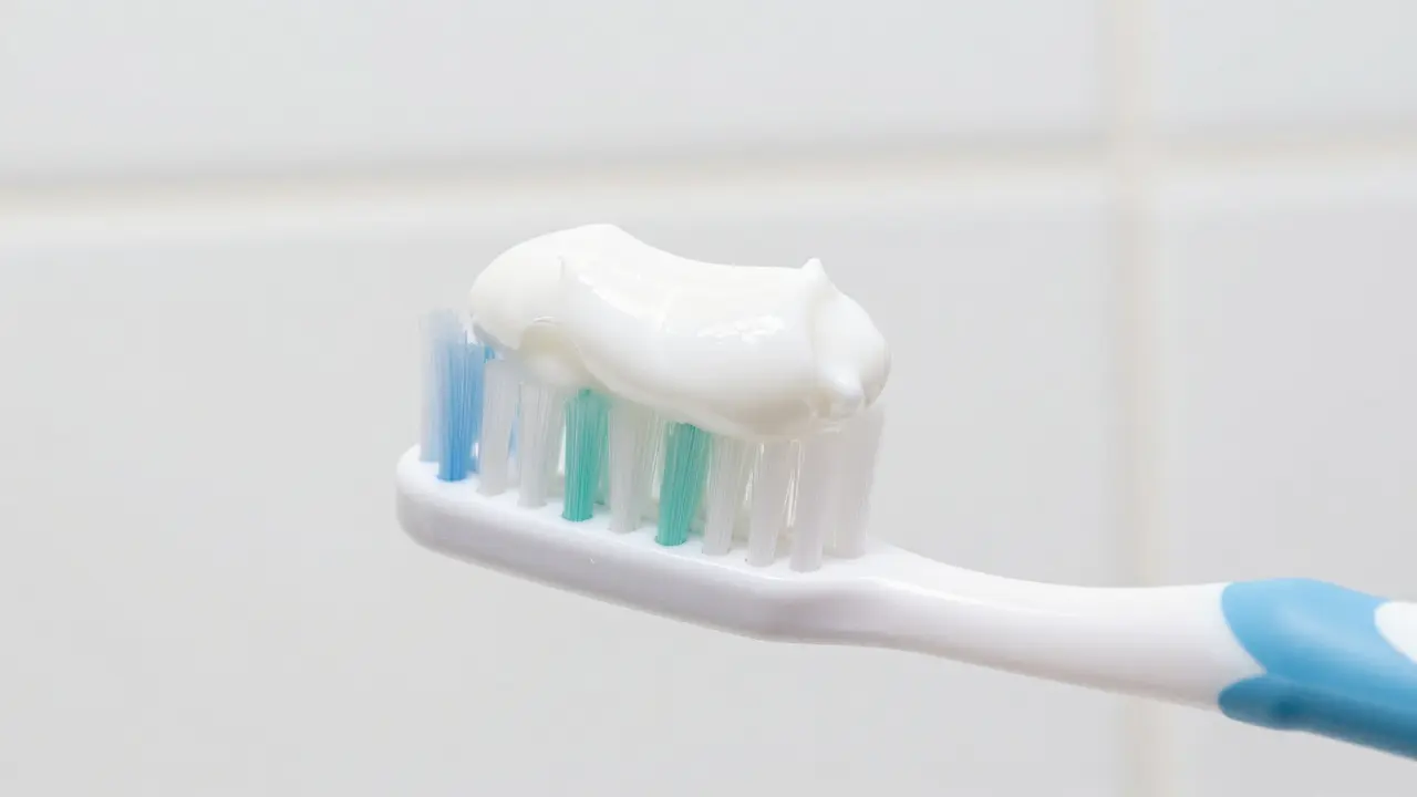 Detail zubní pasty a kartáče pro správnou hygienu a prevenci bolesti.